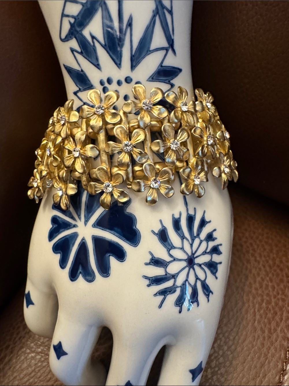 Textured gold tone multi-flower link cuff bracelet embellished w/small crystals